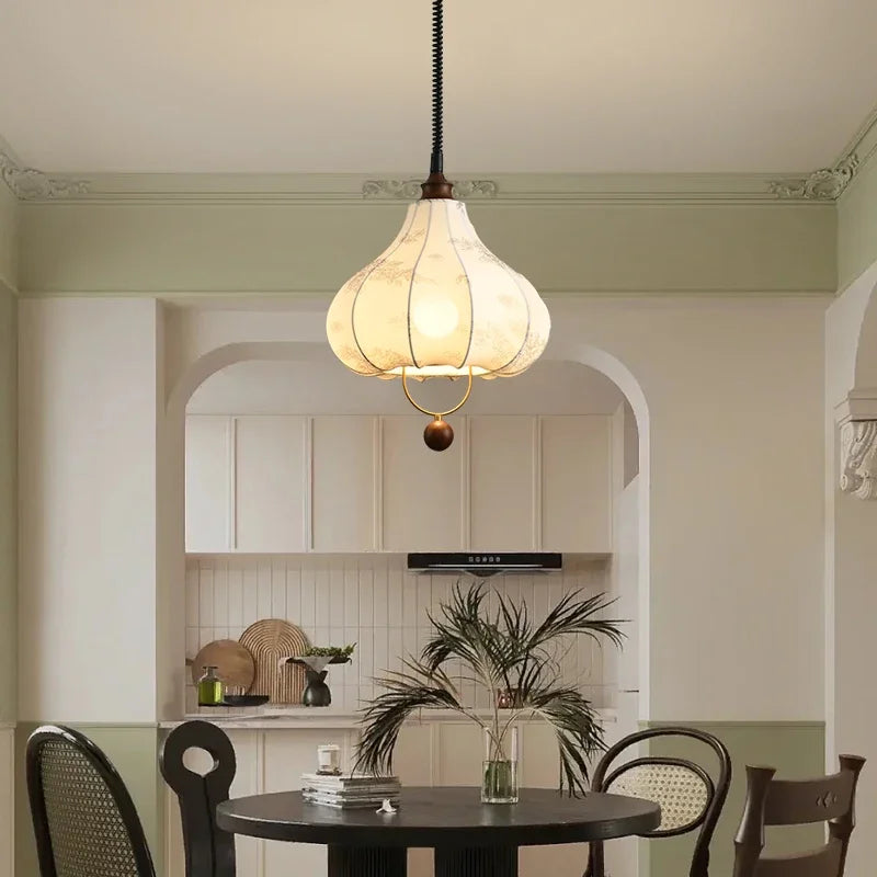 Modern Art Hanging Lamp with teardrop cloth shade and wood accent, a Nordic pendant light for elegant dining spaces.