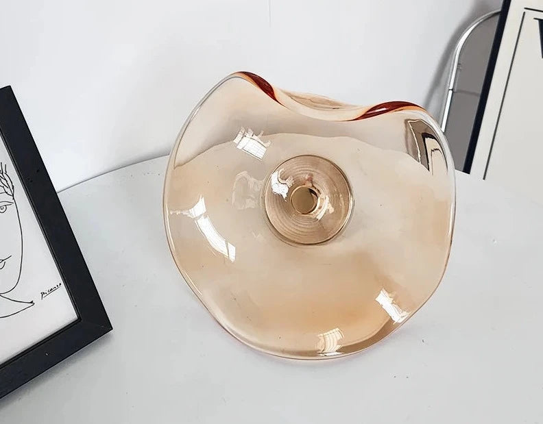 Amber-toned glass modern wall lamp with sculptural art deco design, suitable for bedrooms, dining areas, or hotel wall lighting.