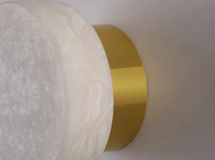 Detail view of gold base and marble shade on Modern LED Wall Lamp, showcasing its premium build and elegant finish.