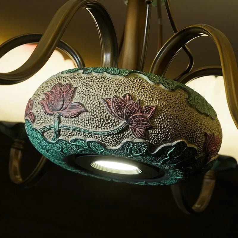 Close-up of lotus blossom LED chandelier base with intricate ceramic floral design, showcasing craftsmanship and elegance.