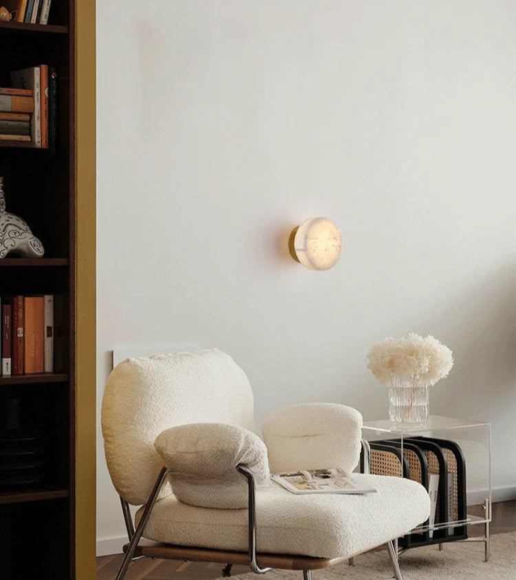 Modern LED Marble Wall Lamp illuminating a reading nook with a plush chair, perfect for cozy and stylish interior lighting.