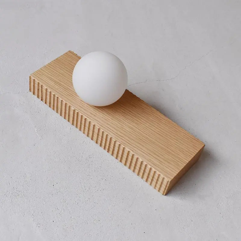 Light oak version of the LUXELY rectangular wood wall lamp with a white globe, perfect for Nordic bedroom decor.