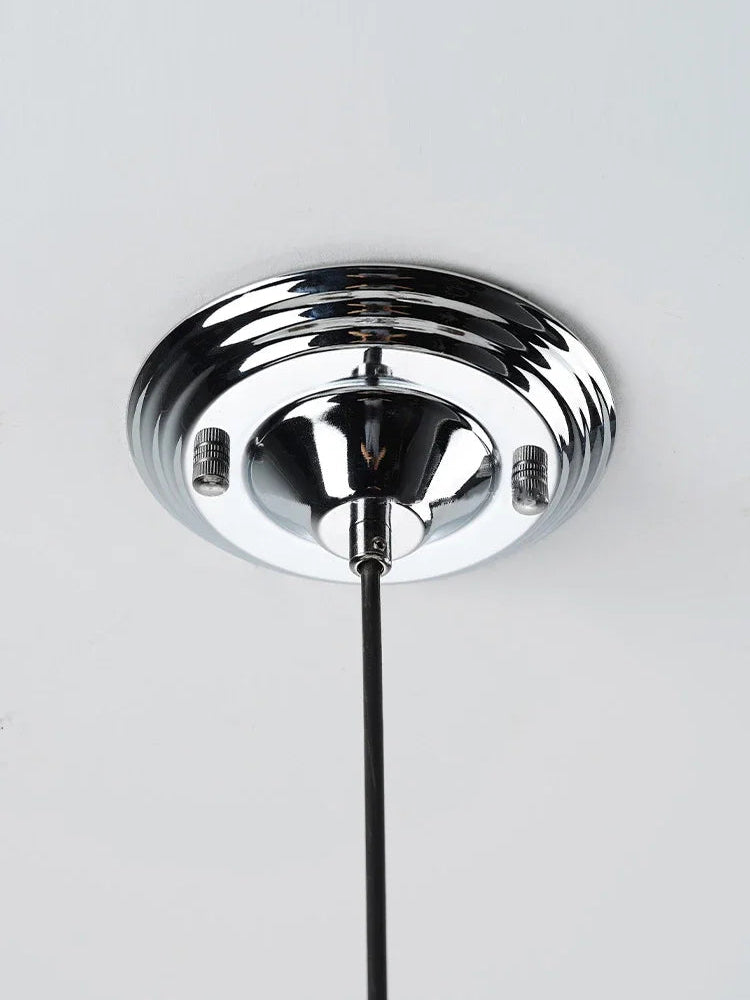 Chrome ceiling mount of Bauhaus retro chandelier, supporting modern LED light fixture for dining or restaurant spaces.