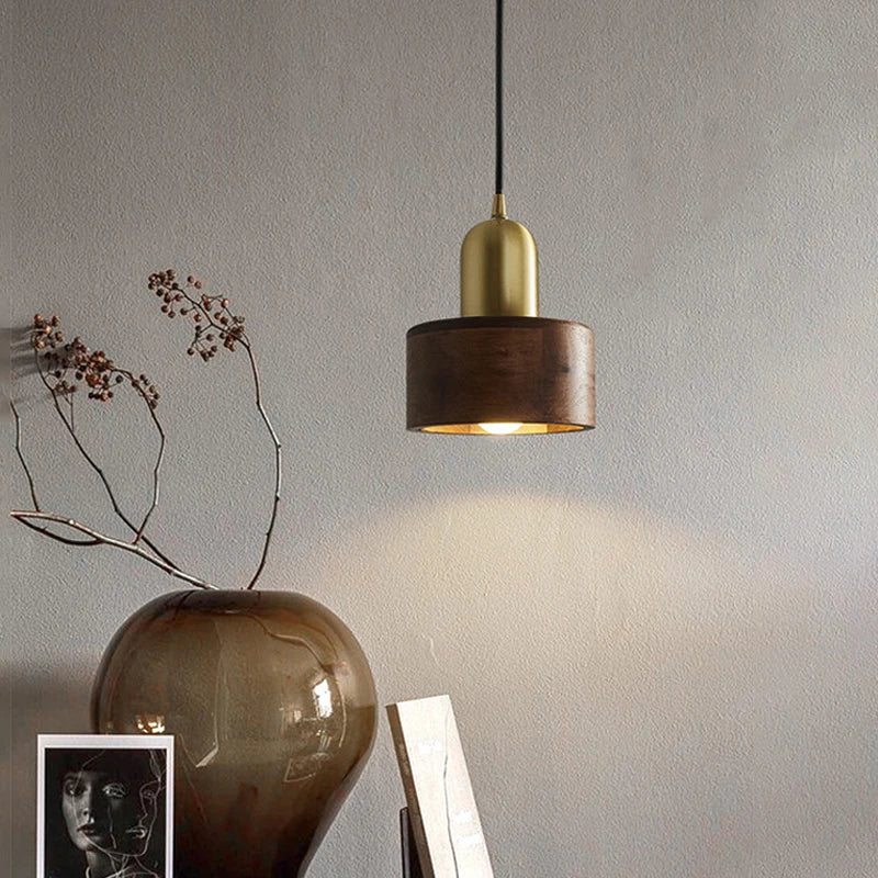 Elegant LUXELY walnut wood and brass pendant light hanging in a minimalist room, ideal for home decor in dining or living areas.