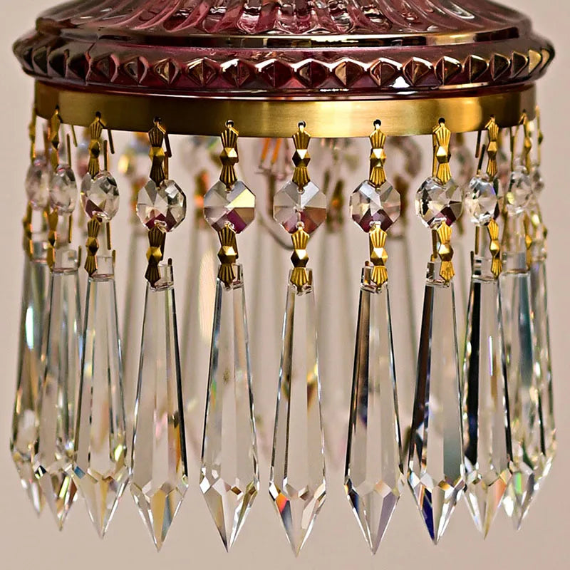 Close-up of luxury French crystal chandelier prisms with gold fittings, showcasing retro elegance and fine craftsmanship.