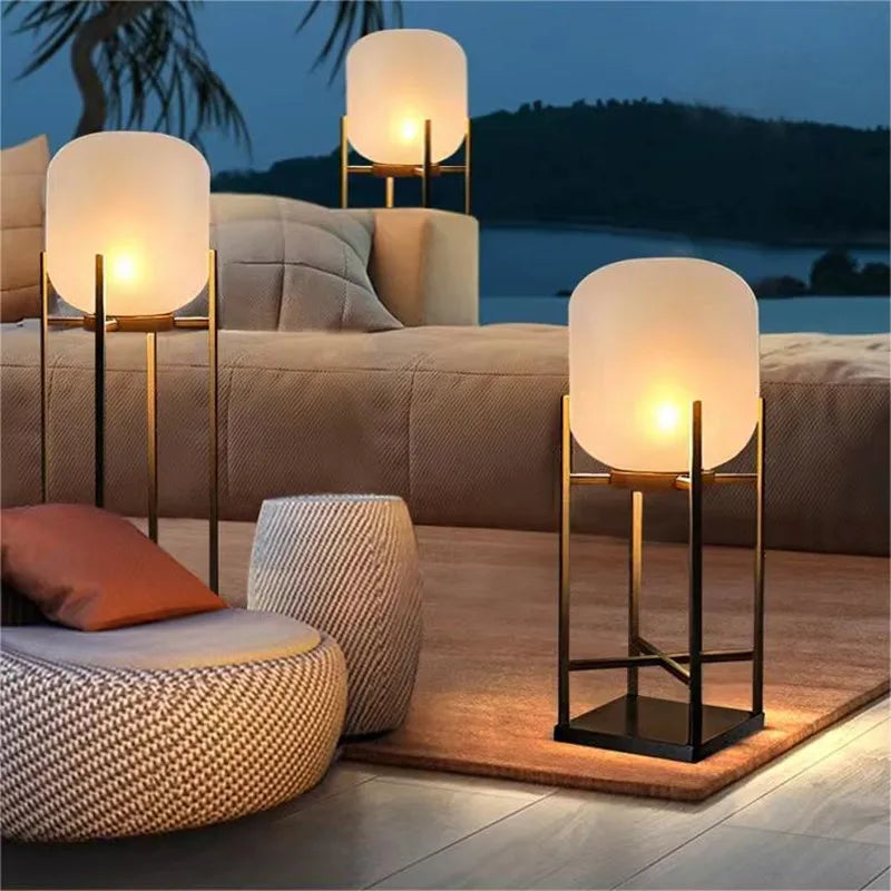 Elegant LUXELY solar garden lights placed around a villa lounge area, creating a warm and inviting outdoor atmosphere.