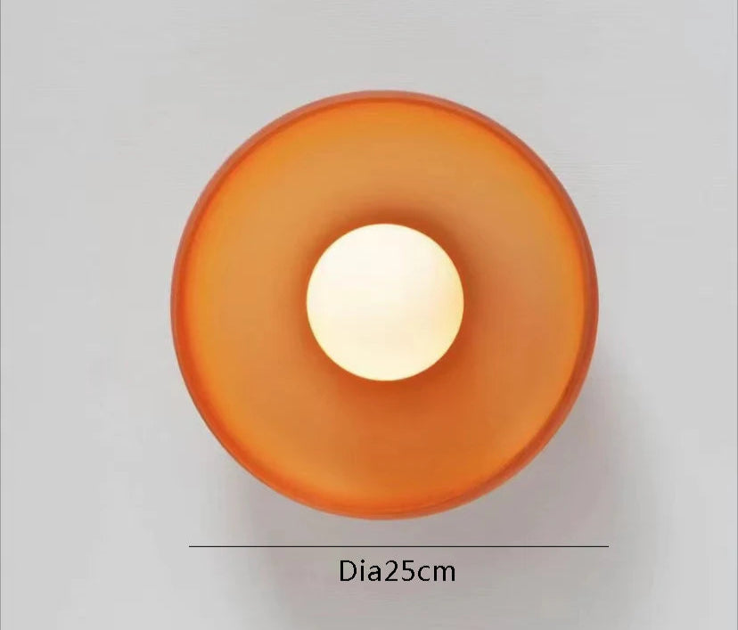 Amber wall light with 25cm diameter and LED bulb. Circular design ideal for accent lighting in modern interiors.