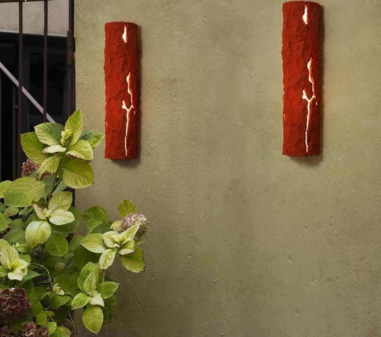 Pair of red LED Resin Wall Lamps on outdoor wall, IP65 waterproof with stone-like finish, ideal for garden or backyard lighting.
