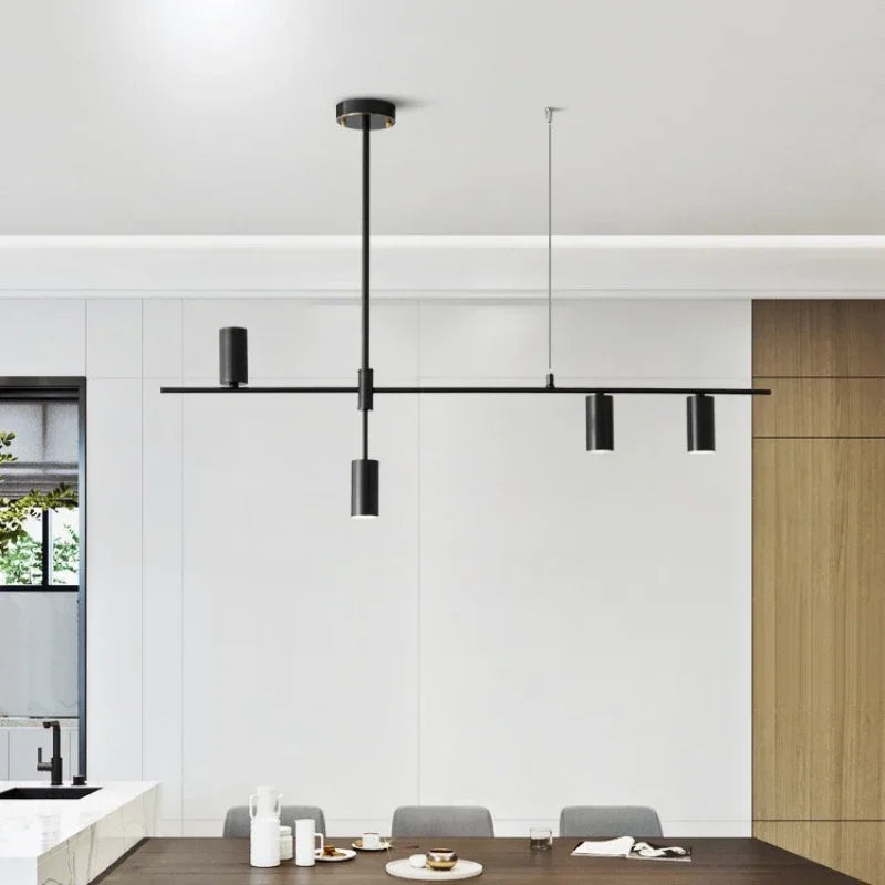 Contemporary dining room featuring black modern minimalist spotlight bar ceiling light with four LED heads for focused lighting.