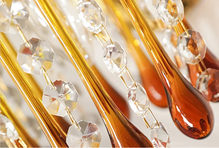 Macro shot of amber teardrop crystals and faceted beads from the French Retro Copper Wall Lamp, showcasing fine craftsmanship.