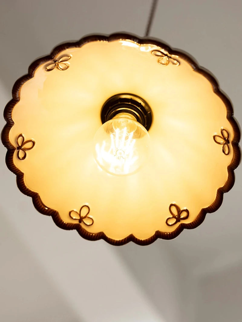Conical ceramic pendant lamp with red wave pattern and LED bulb, ideal for vintage-style home lighting.