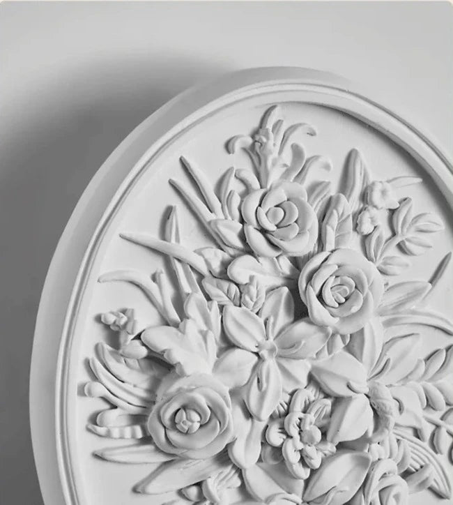 Close-up of oval French vintage sconce with intricate floral carvings, ideal for upscale wall lighting in home or hotel decor.