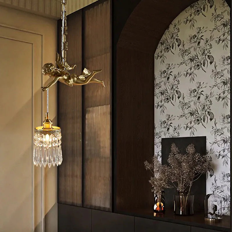 Copper angel chandelier light with crystal pendant installed in a floral-themed interior, adding a romantic vintage touch.