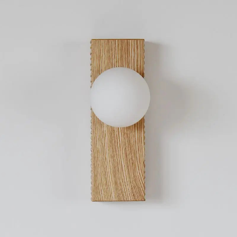 Modern rectangular wood wall lamp in light oak finish, designed for bedrooms with a soft white globe light.