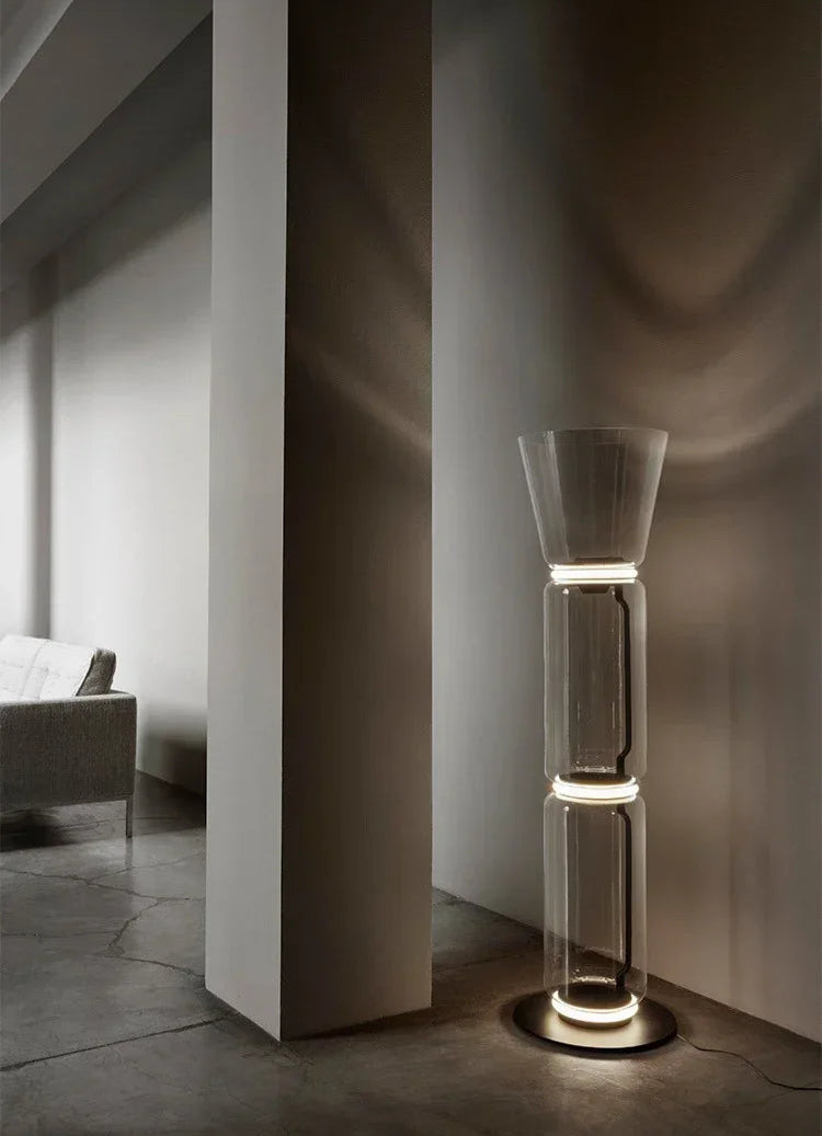 Italian glass floor lamp – nordic minimalist design with three LED-lit glass sections and wide top shade in a modern hallway.