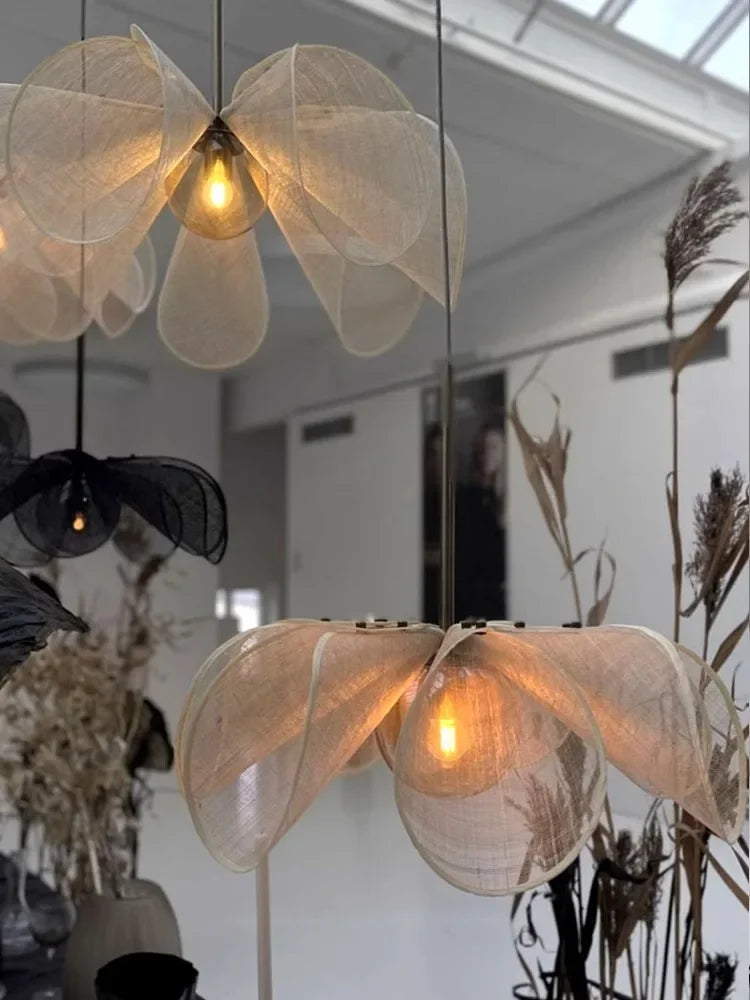 Elegant bubble glass chandelier in modern nordic style, featuring layered translucent fabric petals in a contemporary white interior.