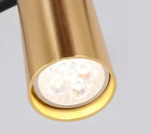 Detailed view of gold LED spotlight head from the modern minimalist ceiling light, showcasing energy-efficient lighting design.