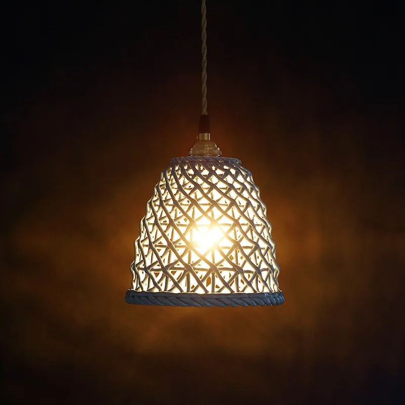 Blue ceramic LED pendant light by LUXELY glowing warmly in a dark room, perfect for ambient restaurant or living room lighting.