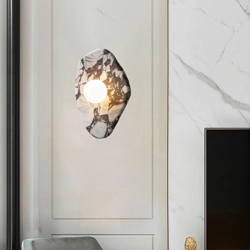 G9 Glass Ball Sconce mounted on a marble wall panel, enhancing hallway lighting with a natural stone aesthetic.