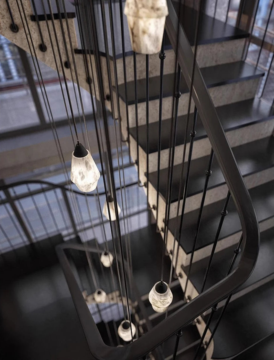 Marble LED pendant lights cascading down a stairwell. Marble LED pendant light – modern ceiling lamp dimmable for architectural elegance.