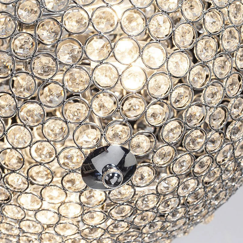 Detail view of luxury LED chandelier showing crystal arrangement and chrome accent at the center.