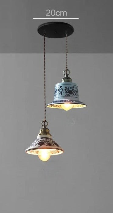 Two ceramic pendant lights with mixed floral patterns on a 20cm ceiling mount, perfect for rustic dining spaces.