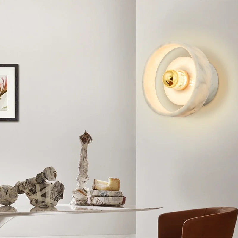 Wabi-sabi marble round wall lamp installed in a modern dining room, adding soft ambient lighting and minimalist elegance.
