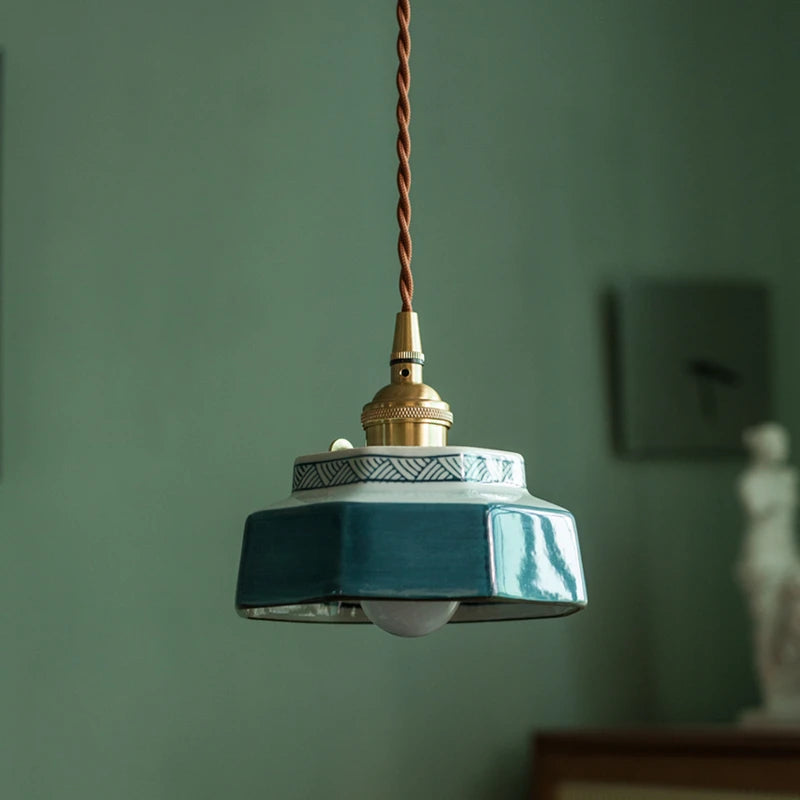 Blue ceramic pendant lamp with LED bulb and copper top, ideal for modern home lighting in dining or living rooms.