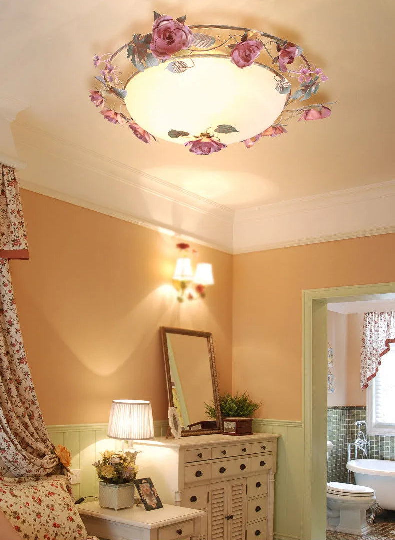 French rose bedroom light fixture with pink roses and soft glow. Romantic chandelier perfect for vintage or cottage-style interiors.