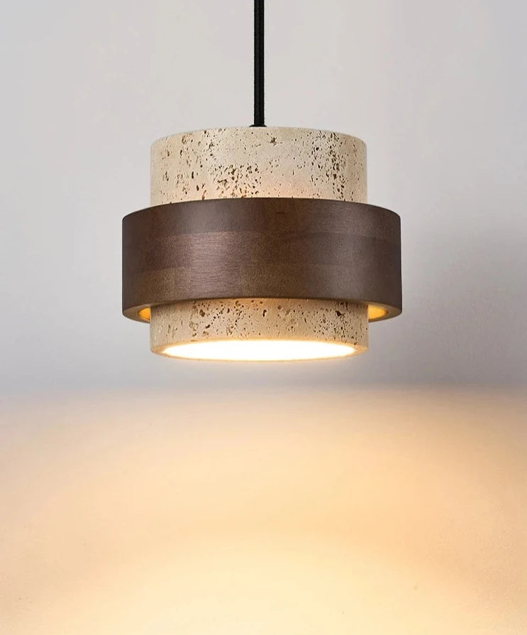 Wabi-sabi travertine pendant lamp bedside emits warm dimmable light, ideal for bedrooms or dining areas with minimalist decor.