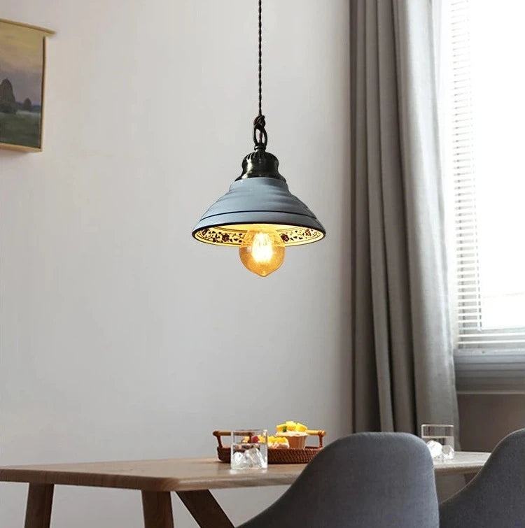 Wide ceramic pendant light with floral interior and LED bulb, perfect for rustic farmhouse dining spaces.