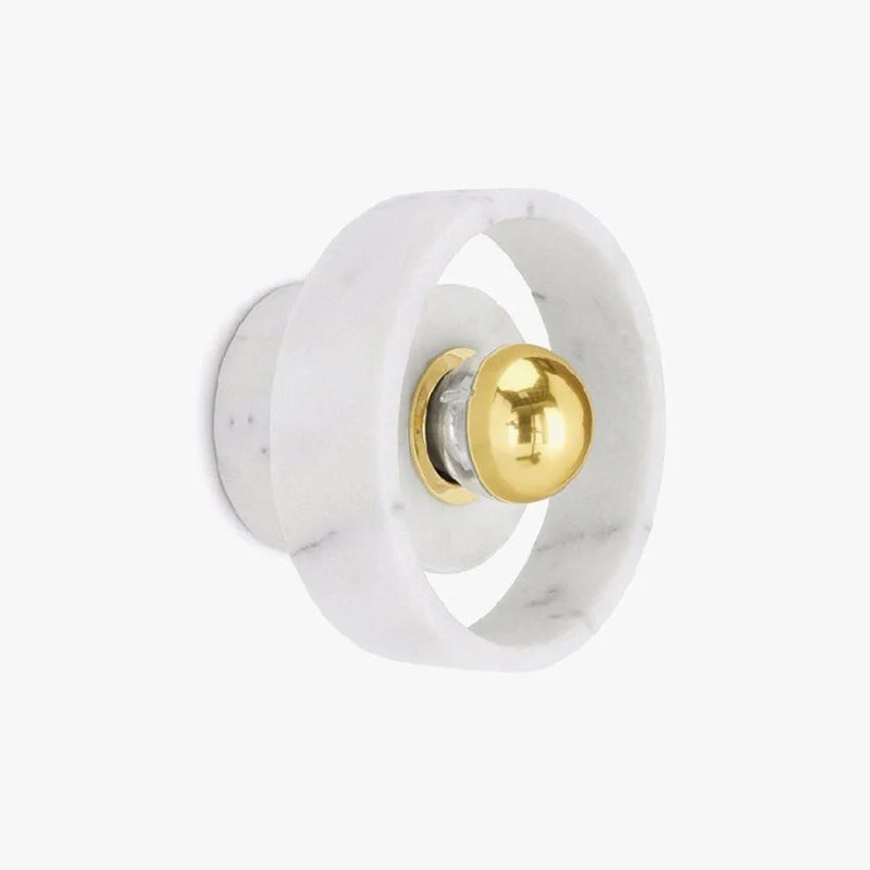 Side view of the marble round wall lamp with gold LED bulb, showcasing minimalist design for modern interiors.