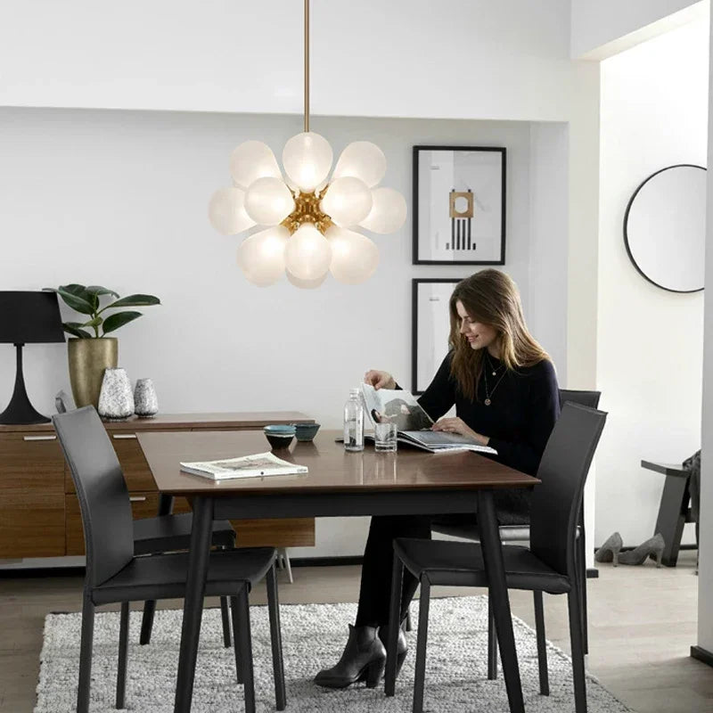 Elegant white bubble glass Nordic chandelier lighting a minimalist dining area, perfect for modern home interiors.