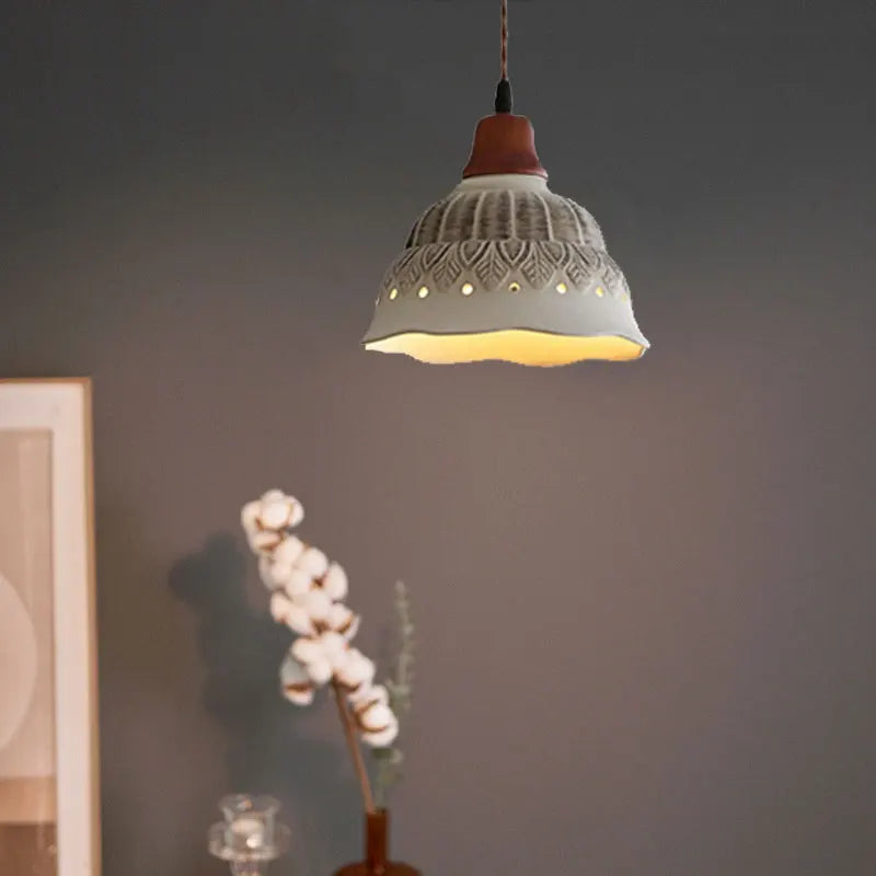 Nordic Ceramic Chandelier - LED Pendant Light Vintage glowing warmly in a dark-toned bedroom with minimalistic decor.