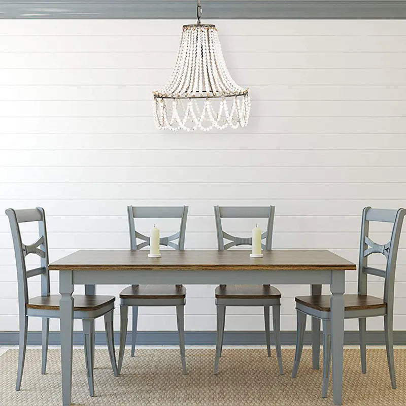 Bohemian Wooden Bead Chandelier above a farmhouse dining table, blending rustic charm with modern decor in a cozy dining room.
