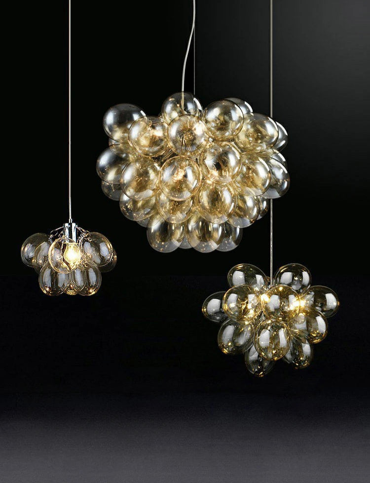 Set of modern grape glass chandeliers in golden tones, perfect for stylish home lighting in living rooms or dining spaces.
