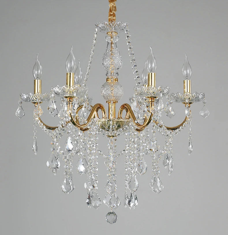 Unlit golden crystal chandelier showcasing intricate crystal and gold detailing for luxury home lighting.