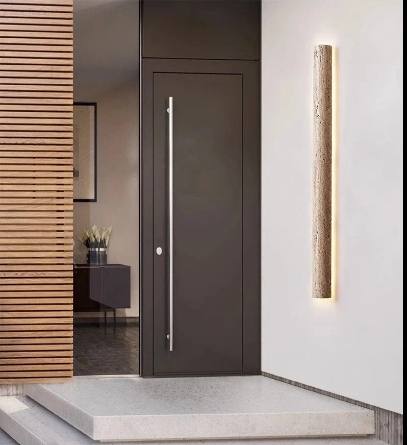 IP65 travertine wall light installed beside modern front door, creating a welcoming and weather-resistant entryway.