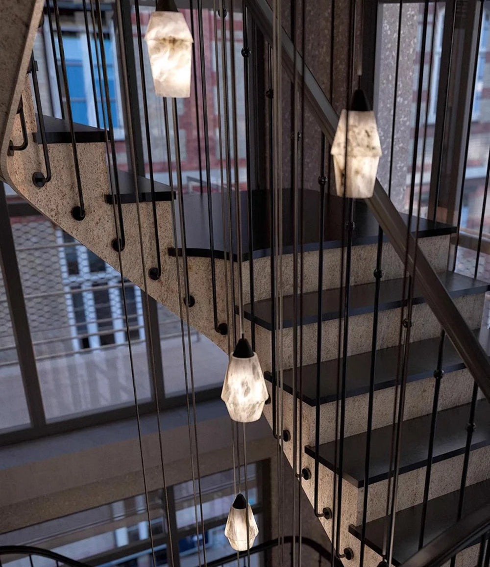 Geometric marble LED pendant lights hanging in stairwell. Marble LED pendant light – modern ceiling lamp dimmable for modern architecture.