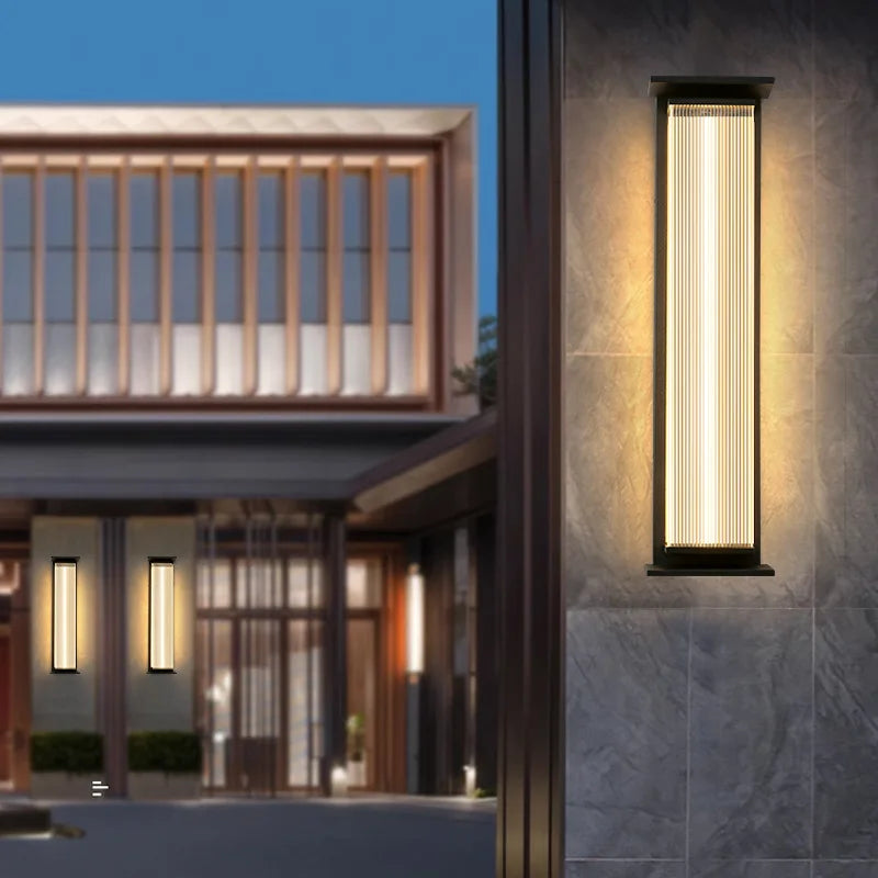 IP65 waterproof stainless steel wall lamp mounted on a modern home's exterior wall, illuminating the entrance.