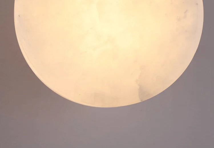 Zoomed-in view of illuminated marble shade on Modern LED Wall Lamp, highlighting its warm glow and stone pattern.