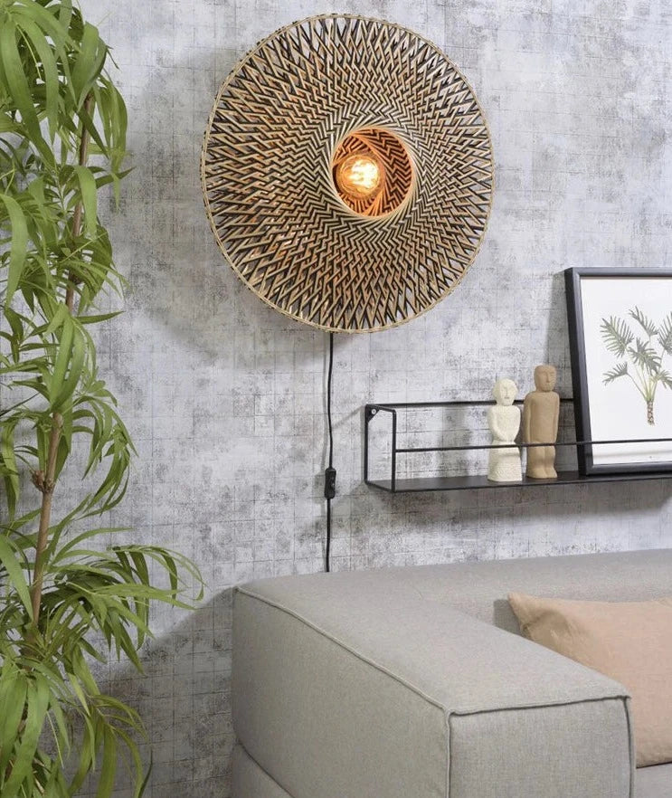 Wabi-sabi bamboo wood wall lamp above a modern sofa with textured gray wall, blending minimalist and natural design elements.