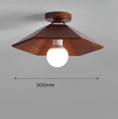 Wabi-sabi inspired ceiling light with a 300mm wide angular walnut wood shade, perfect for dining or hallway lighting.