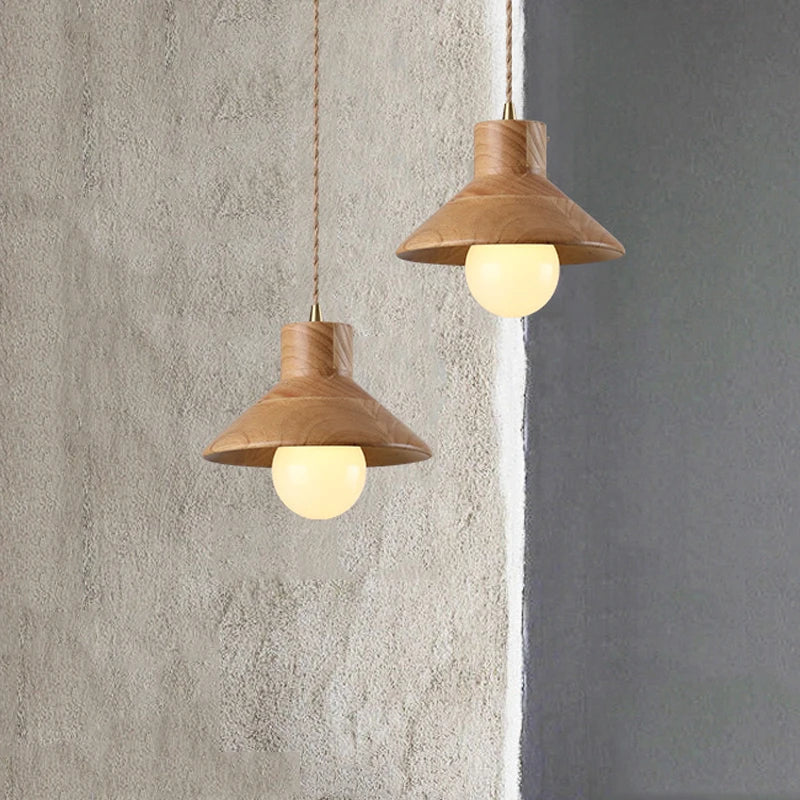 Pair of Nordic wood farmhouse pendant lights hanging against textured wall, stylish for modern dining or kitchen spaces.