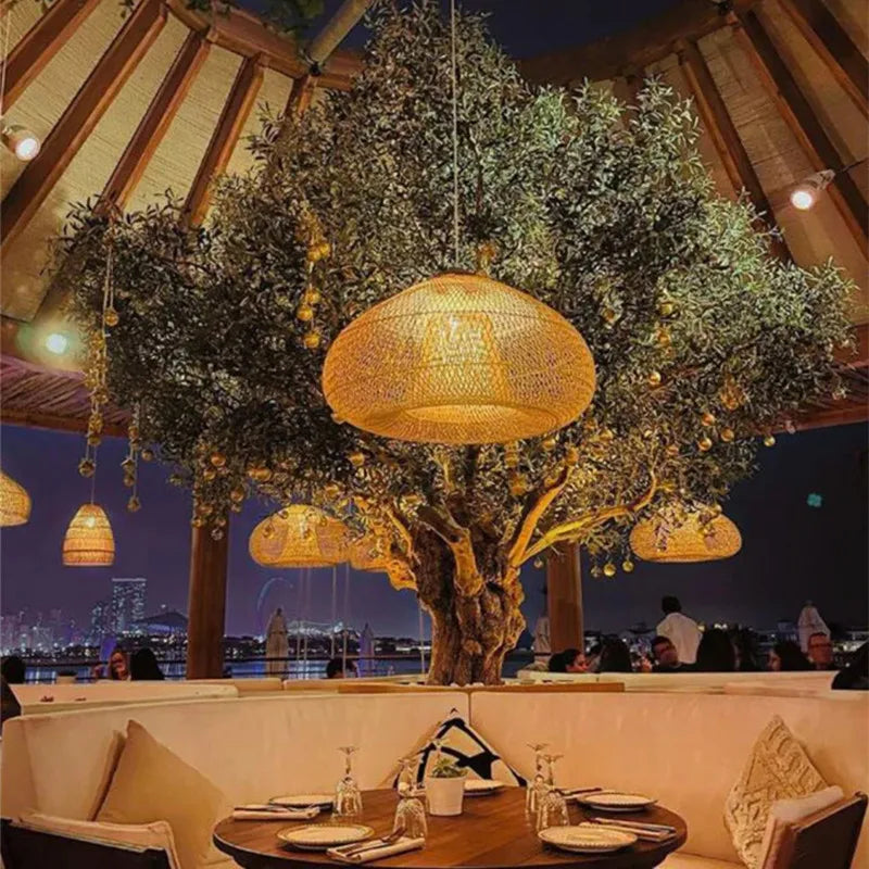 Warm-lit rattan pendant lights hanging in an outdoor restaurant setting, enhancing ambiance with gothic and natural design elements.