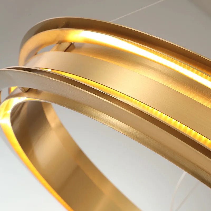 Close-up of brushed gold LED ring chandelier, highlighting the sleek stainless steel finish and integrated lighting.