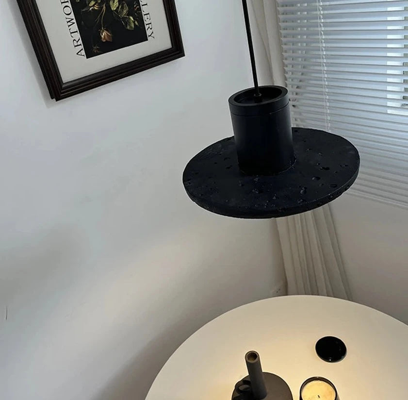 Top view of LUXELY pendant light illuminating a round table, ideal for cozy dining or coffee corner lighting.