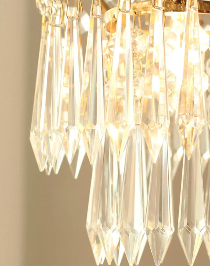 Crystal prisms on copper chandelier reflecting warm light, enhancing ambiance in home lighting fixtures.