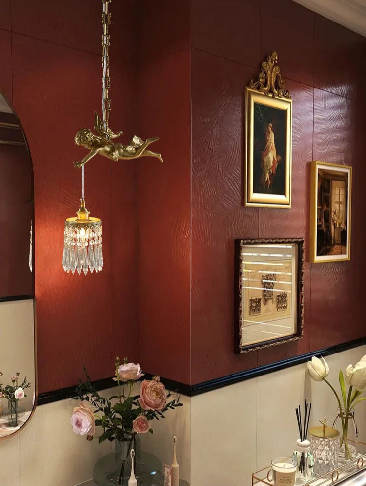 Copper angel chandelier light illuminating a red vintage-themed room, enhancing ambiance with crystal LED lighting.