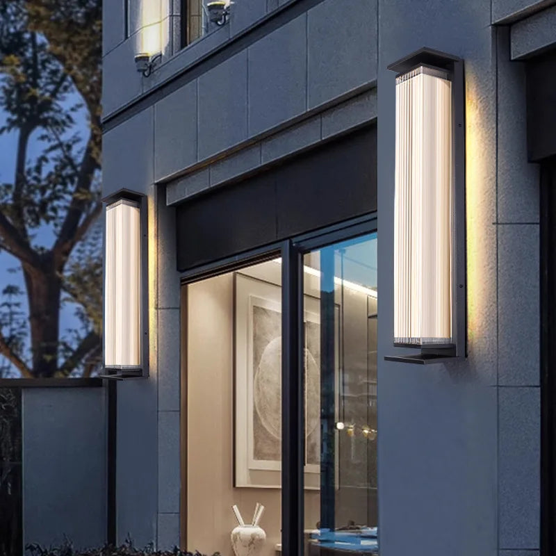 Modern stainless steel outdoor wall lamps mounted beside patio doors, providing waterproof illumination for entryways.